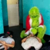 A police officer dressed The Grinch arrests suspected drug dealers in Lima, Peru, on December 23, 2024. Policia Nacional Del Peru / AFP - Getty Images