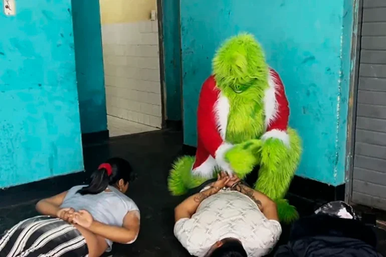 A police officer dressed The Grinch arrests suspected drug dealers in Lima, Peru, on December 23, 2024. Policia Nacional Del Peru / AFP - Getty Images