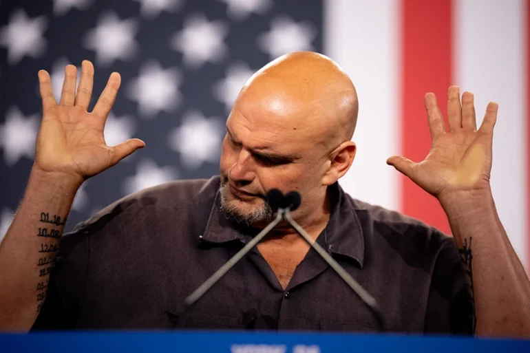 YORK, PENNSYLVANIA - OCTOBER 2: Sen. John Fetterman (D-PA) gestures while speaking at a rally for Democratic vice presidential nominee Minnesota Gov. Tim Walz at York Exposition Center UPMC Arena on October 2, 2024 in York, Pennsylvania. Walz is holding a rally a day after debating Republican vice presidential Nominee Sen. JD Vance (R-OH) at the CBS Broadcast Center in New York City. (Photo by Andrew Harnik/Getty Images)