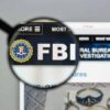 Magnifying glass over FBI logo on webpage