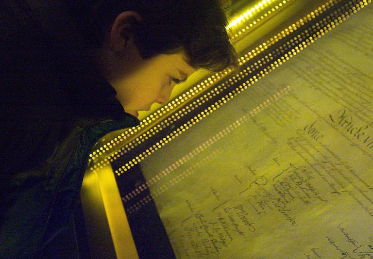 WASHINGTON - DECEMBER 15: Ethan Kasnett, an 8th grade student at the Lab School in Washington, DC, views the original constitution after a ceremony unveiling the people's choice of the top ten most influential documents that shaped the United States of America at the National Archives December 15, 2003 in Washington, DC. The event and vote were co-sponsored by The People's Vote, the National Archives and Records Administration, National History Day, and U.S. News & World Report. Among the records chosen were the Declaration of Independence at number one and the Constitution at number two. (Photo by Brendan Smialowski/Getty Images)