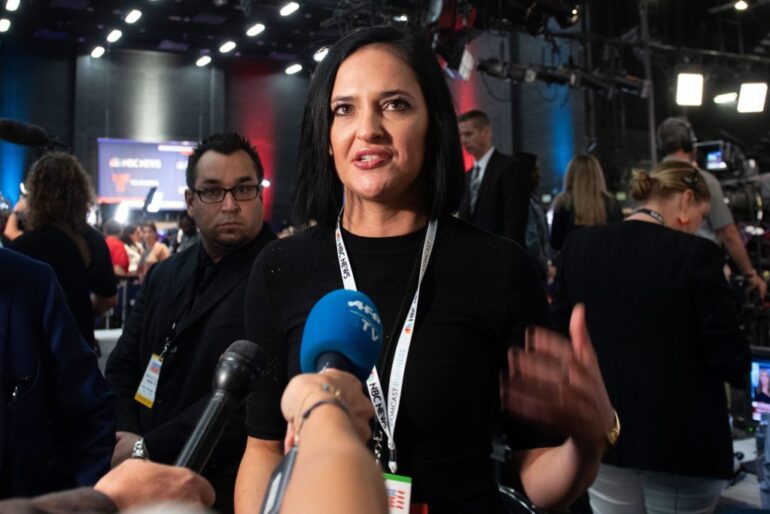 Lis Smith, spokesperson for Democratic presidential candidate Pete Buttigieg, addressing the press with microphones after a 2020 debate.