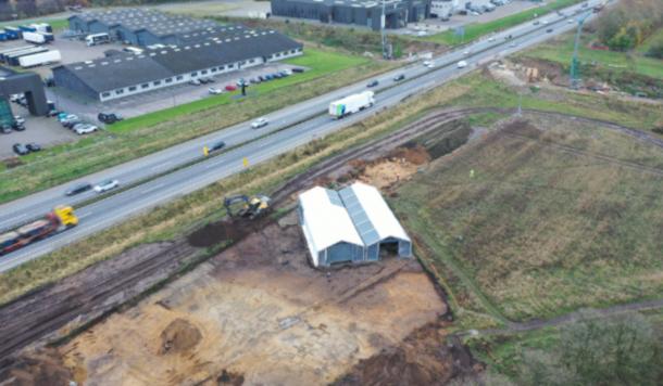 Aerial view of the Løsning Søndermark excavation site along a busy Danish motorway.