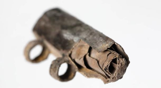 Close-up photograph of rolled up silver foil scroll inside silver amulet from third century BC, found in Frankfurt, Germany.