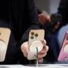 A man checks an iPhone 16 Pro as the new iPhone 16 series smartphones go on sale at an Apple store in Beijing, China September 20, 2024. REUTERS/Florence Lo/File Photo