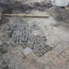 Tile floor patched with cow bones, found during excavations in Alkmaar city center.