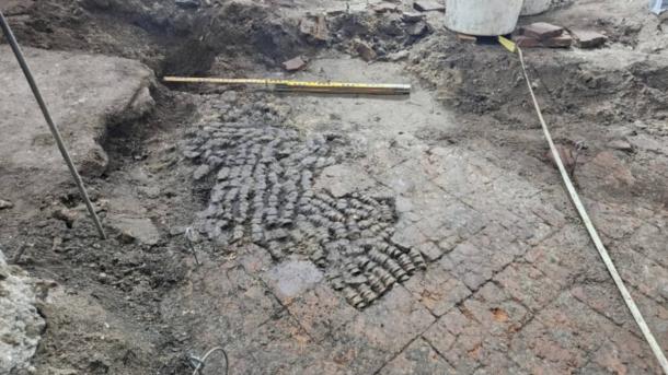 Tile floor patched with cow bones, found during excavations in Alkmaar city center.