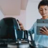 Woman setting up air fryer using tablet