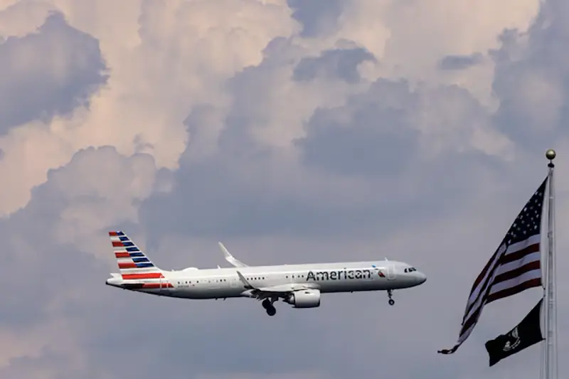 An American Airlines commercial aircraft flies over Washington as it approaches to land at Dulles International Airport, as seen from Washington, U.S., August 5, 2024. REUTERS/ Umit Bektas/File Photo