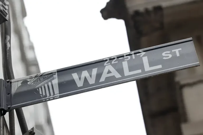 A street sign marks Wall Street outside the New York Stock Exchange (NYSE) in New York City.  REUTERS/Caitlin Ochs/File Photo