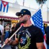 Henry "Enrique" Tarrio, leader of The Proud Boys, holds an US flags during a protest showing support for Cubans demonstrating against their government, in Miami, Florida on July 16, 2021. (Photo by Eva Marie UZCATEGUI / AFP) (Photo by EVA MARIE UZCATEGUI/AFP via Getty Images)