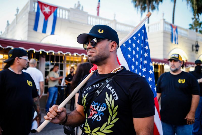 Henry "Enrique" Tarrio, leader of The Proud Boys, holds an US flags during a protest showing support for Cubans demonstrating against their government, in Miami, Florida on July 16, 2021. (Photo by Eva Marie UZCATEGUI / AFP) (Photo by EVA MARIE UZCATEGUI/AFP via Getty Images)