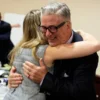 TOPSHOT - US actor Alec Baldwin hugs a member of his legal team at the conclucion of his trial on involuntary manslaughter at Santa Fe County District Court in Santa Fe, New Mexico, on July 12, 2024. Baldwin's trial for involuntary manslaughter was dismissed by a judge Friday after she ruled that key evidence over a fatal shooting on the set of "Rust" had been withheld from the defense. (Photo by RAMSAY DE GIVE / POOL / AFP) (Photo by RAMSAY DE GIVE/POOL/AFP via Getty Images)