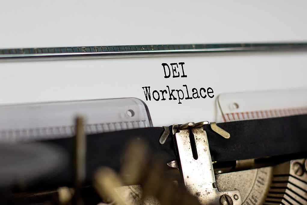 Typewriter with paper reading DEI Workplace