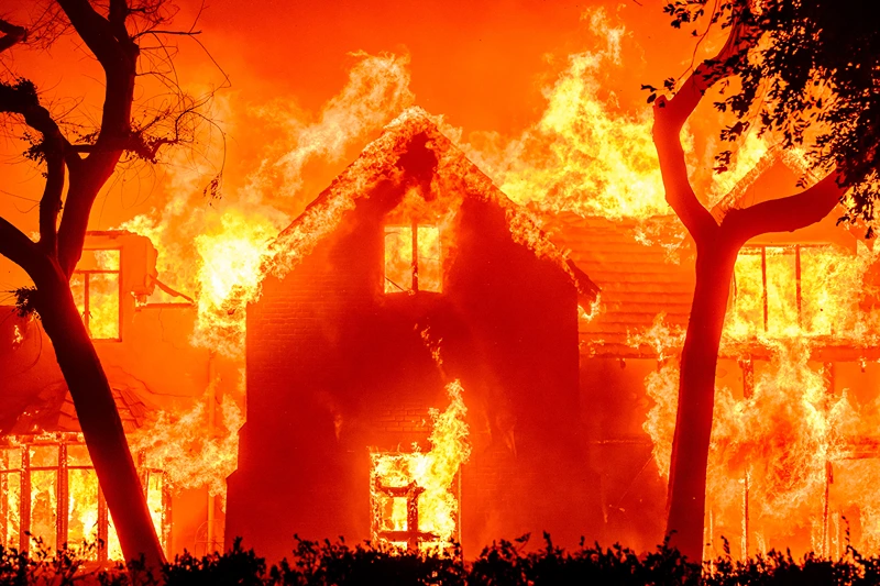 TOPSHOT - A home is engulfed in flames during the Eaton fire in the Altadena area of Los Angeles County, California on January 8, 2025. (Photo by JOSH EDELSON / AFP) (Photo by JOSH EDELSON/AFP via Getty Images)