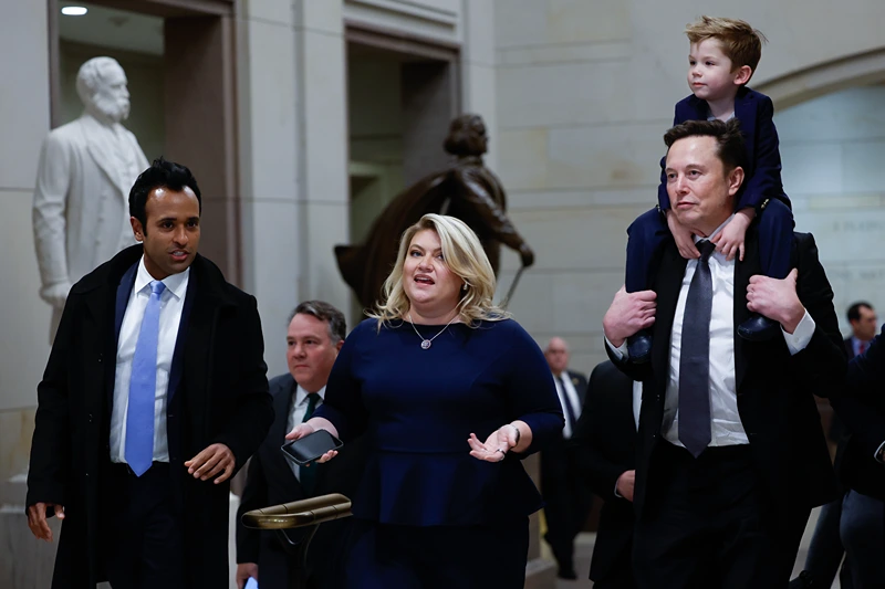 WASHINGTON, DC - DECEMBER 05: Tesla CEO Elon Musk (R), Co-Chair of the newly announced Department of Government Efficiency (DOGE) carries his son on his shoulders at the U.S. Capitol following a meeting with businessman Vivek Ramaswamy (L), Co-Chair of the newly announced Department of Government Efficiency, Rep. Kat Cammack (C), and other members of the U.S. Congress on December 05, 2024 in Washington, DC. Musk and Ramaswamy are meeting with members of the U.S. Congress today about DOGE, a planned presidential advisory commission with the goal of cutting government spending and increasing efficiency in the federal workforce. (Photo by Anna Moneymaker/Getty Images)