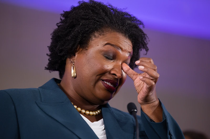 ATLANTA, GA - NOVEMBER 08: Democratic gubernatorial candidate Stacey Abrams wipes her eye during a concession speech to supporters during an election-night party on November 8, 2022 in Atlanta, Georgia. Abrams lost her bid for governor to incumbent Gov. Brian Kemp in a rematch of their 2018 race. (Photo by Jessica McGowan/Getty Images)