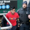 NYPD officers escort suspect Sebastian Zepata-Calil, wanted for a homicide on the subway in Coney Island, out of TD2 in lower Manhattan Sunday, Dec. 22, 2024.