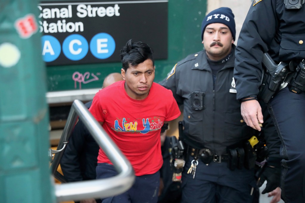 NYPD officers escort suspect Sebastian Zepata-Calil, wanted for a homicide on the subway in Coney Island, out of TD2 in lower Manhattan Sunday, Dec. 22, 2024.