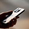 FILE PHOTO: A man holds an iPhone 14 as Apple Inc's new models go on sale at an Apple store in Beijing, China, September 16, 2022. REUTERS/Thomas Peter/File Photo