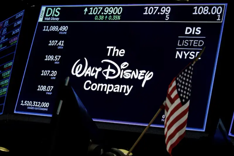 A screen shows the logo and a ticker symbol for The Walt Disney Company on the floor of the New York Stock Exchange (NYSE) in New York, U.S., December 14, 2017. REUTERS/Brendan McDermid/File Photo