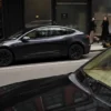 People walk past a Tesla car parked in the Meatpacking District of New York City, U.S., January 02, 2025. REUTERS/Adam Gray/File Photo