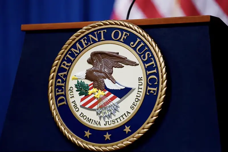 The seal of the U.S. Justice Department is seen on the podium in the Department's headquarters briefing room before a news conference with the Attorney General in Washington, January 24, 2023. REUTERS/Kevin Lamarque//File Photo