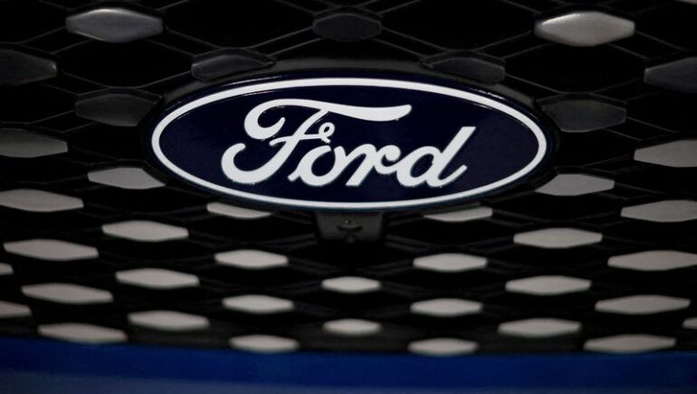 FILE PHOTO: The Ford logo is seen on the grill of an E-transit concept vehicle at the Ford Halewood transmissions plant in Liverpool, Britain, December 1, 2022. REUTERS/Phil Noble//File Photo