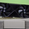 An RTX 5090 sitting on top of its retail packaging against a green background