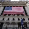 U.S. flags hang on the building of the New York Stock Exchange (NYSE), after U.S. President-elect Donald Trump won the presidential election, in New York City, U.S., November 6, 2024. REUTERS/Andrew Kelly/File photo