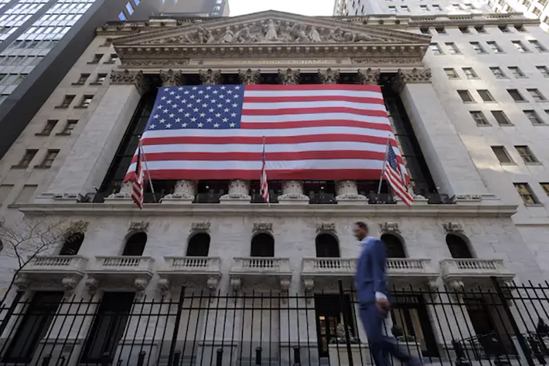 U.S. flags hang on the building of the New York Stock Exchange (NYSE), after U.S. President-elect Donald Trump won the presidential election, in New York City, U.S., November 6, 2024. REUTERS/Andrew Kelly/File photo