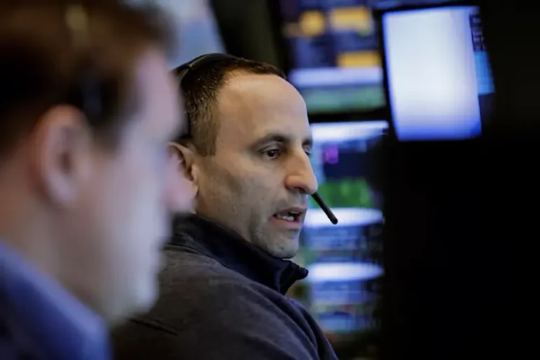 Traders work on the floor at the New York Stock Exchange (NYSE) in New York City, U.S., February 24, 2025. REUTERS/Brendan McDermid/File Photo