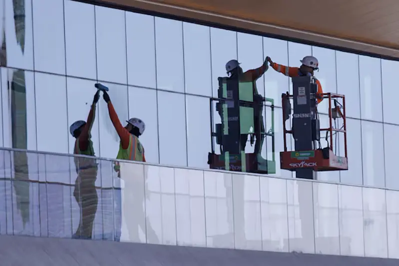 Construction workers install windows on a nearly completed office building in San Diego, California, U.S., October 9, 2024. REUTERS/Mike Blake/File Photo