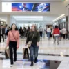 People carrying shopping bags walk inside the King of Prussia shopping mall in King of Prussia, Pennsylvania, U.S. November 26, 2021. REUTERS/Rachel Wisniewski/File Photo