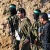 TOPSHOT - Palestinian militant group Hamas fighters escort Israeli-French hostage Ofer Kalderon before handing him over to a Red Cross team in Khan Yunis on February 1, 2025, as part of fourth hostage-prisoner exchange. (Photo by Eyad BABA / AFP) (Photo by EYAD BABA/AFP via Getty Images)