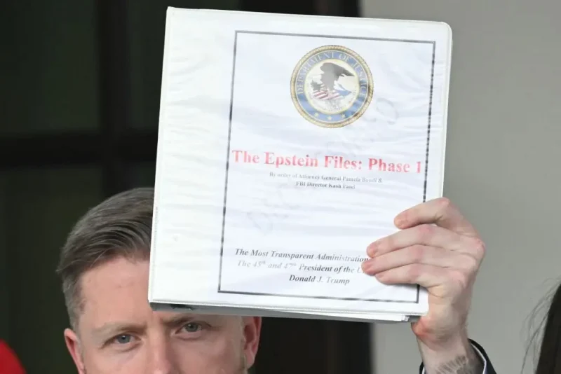 Political commentator Rogan O'Handley, aka DC Draino, and other unidentified people carrying binders bearing the seal of the US Justice Department reading "The Epstein Files: Phase 1" walk out of the West Wing of the White House in Washington, DC, on February 27, 2025. The Trump administration has said it would release documents on late tycoon and convicted sex trafficker Jeffrey Epstein who was found dead in his prison cell in 2019. (Photo by SAUL LOEB / AFP) (Photo by SAUL LOEB/AFP via Getty Images)