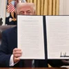 US President Donald Trump holds the executive order he signed to declassify the files of slained former President John F. Kennedy, former Attorney General Robert F. Kennedy and civil rights leader Martin Luther King Jr., in the Oval Office of the White House in Washington, DC, on January 23, 2025. (Photo by ROBERTO SCHMIDT / AFP) (Photo by ROBERTO SCHMIDT/AFP via Getty Images)