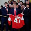 WASHINGTON, DC - FEBRUARY 03: U.S. President Donald Trump receives a jersey and a hockey stick from Florida Panthers Matthew Tkachuk (R) and Aleksander Barkov as Trump honored the Florida Panthers in the East Room of the White House on February 03, 2025 in Washington, DC. The Florida Panthers are the 2024 Stanley Cup Champions. (Photo by Kevin Dietsch/Getty Images)