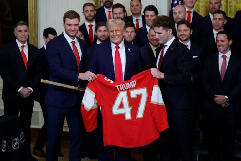 WASHINGTON, DC - FEBRUARY 03: U.S. President Donald Trump receives a jersey and a hockey stick from Florida Panthers Matthew Tkachuk (R) and Aleksander Barkov as Trump honored the Florida Panthers in the East Room of the White House on February 03, 2025 in Washington, DC. The Florida Panthers are the 2024 Stanley Cup Champions. (Photo by Kevin Dietsch/Getty Images)