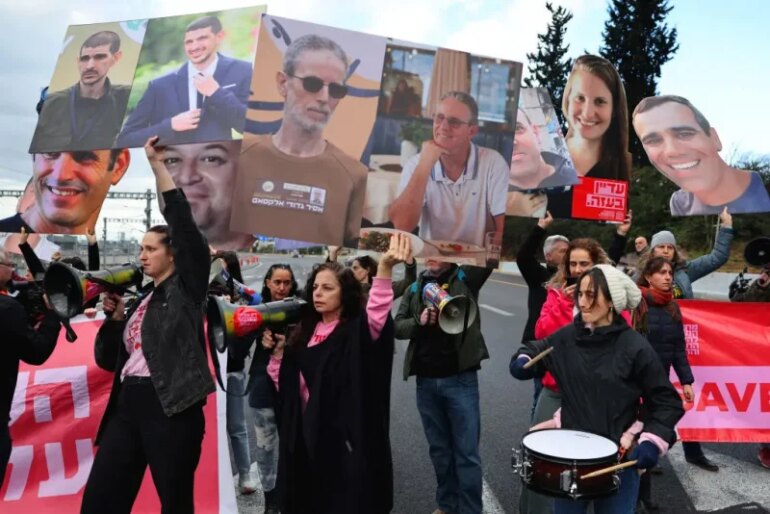 Relatives and supporters of Israeli hostages held in Gaza since the October 7, 2023 attacks, block Ayalon Highway in Tel Aviv during a protest calling for the release of all hostages, on February 13, 2025. Israel on January 12, threatened to launch a "new" war on Hamas and implement US President Donald Trump's plan to displace Palestinians from the ravaged Gaza Strip if the militants do not release hostages this weekend. (Photo by JACK GUEZ / AFP) (Photo by JACK GUEZ/AFP via Getty Images)