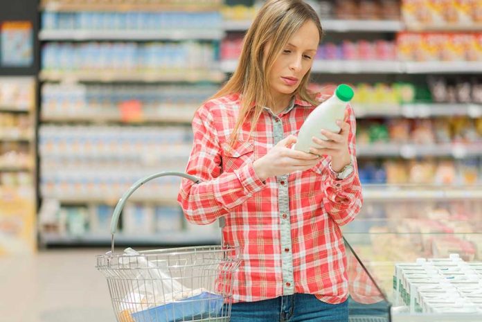 Woman reading label in grocery store aisle