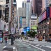 Times Square street scene with storefronts and advertisements.