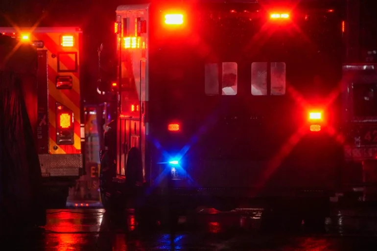 WASHINGTON, DC - JANUARY 31: Ambulances drive off as local first responders salute the flag draped bodies of service members killed in the aviation crash at a temporary emergency disaster site at Buzzards Point on January 31, 2025 in Washington, DC. An American Airlines flight from Wichita, Kansas collided with a helicopter while approaching Ronald Reagan National Airport. (Photo by Andrew Harnik/Getty Images)