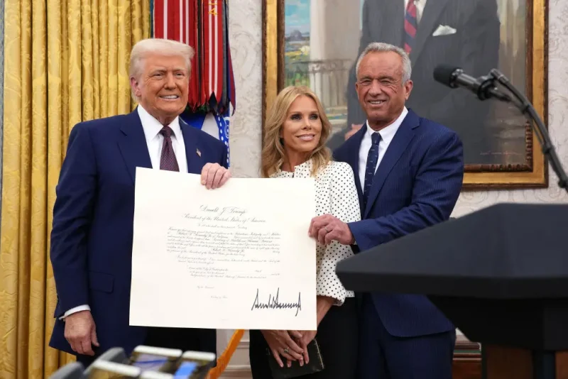 WASHINGTON, DC - FEBRUARY 13: U.S. President Donald Trump, Robert F. Kennedy Jr., and Kennedy's wife Cheryl Hines pose after Kennedy was sworn in as Secretary of Health and Human Services in the Oval Office at the White House on February 13, 2025 in Washington, DC. Kennedy, who faced criticism for his past comments on vaccine, was confirmed by the Senate 52 to 48. Former Senate Republican Leader Mitch McConnell (R-KY) was the only Republican to vote against him. (Photo by Andrew Harnik/Getty Images)