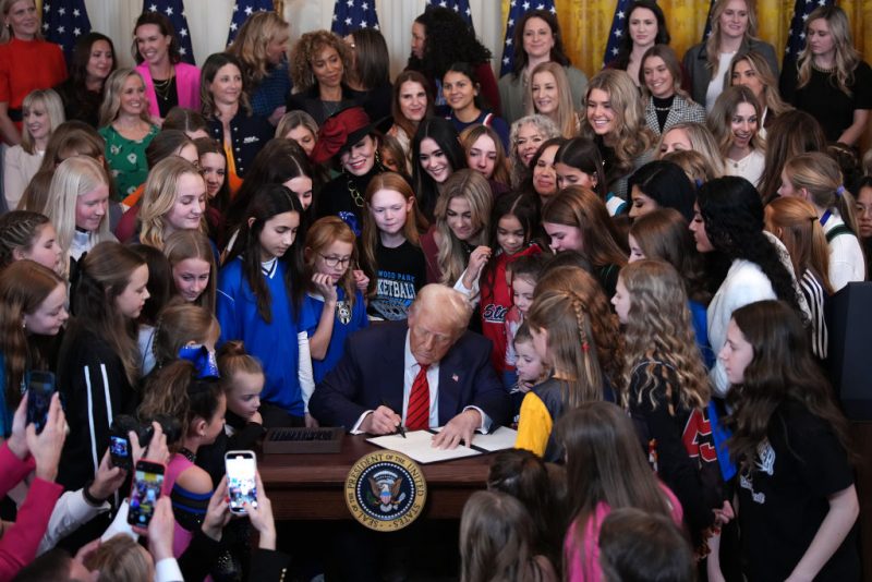 WASHINGTON, DC - FEBRUARY 05: U.S. President Donald Trump joined by women athletes signs the “No Men in Women’s Sports” executive order in the East Room at the White House on February 5, 2025 in Washington, DC. The executive order, which Trump signed on National Girls and Women in Sports Day, prohibits transgender women from competing in women’s sports and is the third order he has signed that targets transgender people. (Photo by Andrew Harnik/Getty Images)