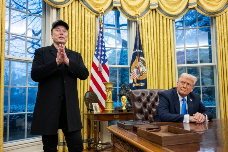 Elon Musk speaks as US President Donald Trump looks on in the Oval Office of the White House in Washington, DC, on February 11, 2025. Tech billionaire Elon Musk, who has been tapped by President Donald Trump to lead federal cost-cutting efforts, said the United States would go "bankrupt" without budget cuts. Musk leads the efforts under the newly created Department of Government Efficiency (DOGE), and was speaking at the White House with Trump, who has in recent weeks unleashed a flurry of orders aimed at slashing federal spending. (Photo by Jim WATSON / AFP) (Photo by JIM WATSON/AFP via Getty Images)