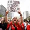 TOPSHOT - Anti-gun demonstrators protest at the Tennessee Capitol for stricter gun laws in Nashville, Tennessee, on April 3, 2023. - Students were encouraged by an anti-gun violence group to walk out of classrooms at 10:13 AM, the same time police say a transgender person entered The Covenant School beginning an attack in which three young children and three adults were killed last week at a private Christian school in Nashville. (Photo by John Amis / AFP) (Photo by JOHN AMIS/AFP via Getty Images)