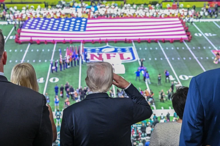 TOPSHOT - US President Donald Trump salutes as the national anthem is played before the start of Super Bowl LIX between the Kansas City Chiefs and the Philadelphia Eagles at Caesars Superdome in New Orleans, Louisiana, February 9, 2025. (Photo by ROBERTO SCHMIDT / AFP) (Photo by ROBERTO SCHMIDT/AFP via Getty Images)