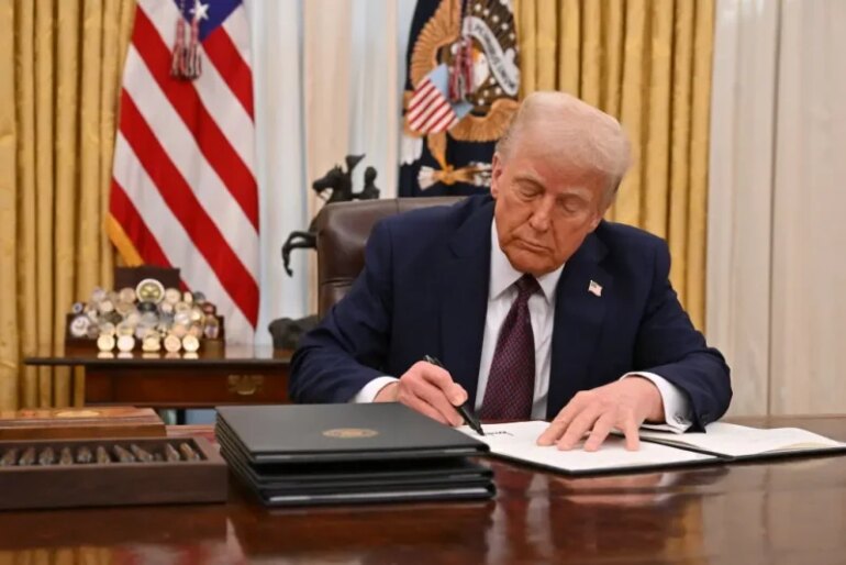 US President Donald Trump signs an executive order to declassify files of former President John F. Kennedy, former Attorney General Robert F. Kennedy and civil rights leader Martin Luther King Jr., in the Oval Office of the White House in Washington, DC, on January 23, 2025. (Photo by ROBERTO SCHMIDT / AFP) (Photo by ROBERTO SCHMIDT/AFP via Getty Images)