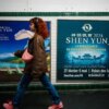 This photograph taken on March 1, 2024, shows a woman walking past posters of the Shen Yun dance show in a metro station in Paris. Dancers dressed in colourful costumes gracefully twirl in front of digitised landscapes of China, with an ambiguous message in the background: since 2006, the Chinese-American company Shen Yun, currently on tour in France, has used its grandiose shows to spread vehement criticism of Beijing and conservative rhetoric around the world. (Photo by Dimitar DILKOFF / AFP) (Photo by DIMITAR DILKOFF/AFP via Getty Images)